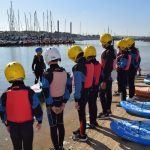 students getting ready for a paddleboarding sessions