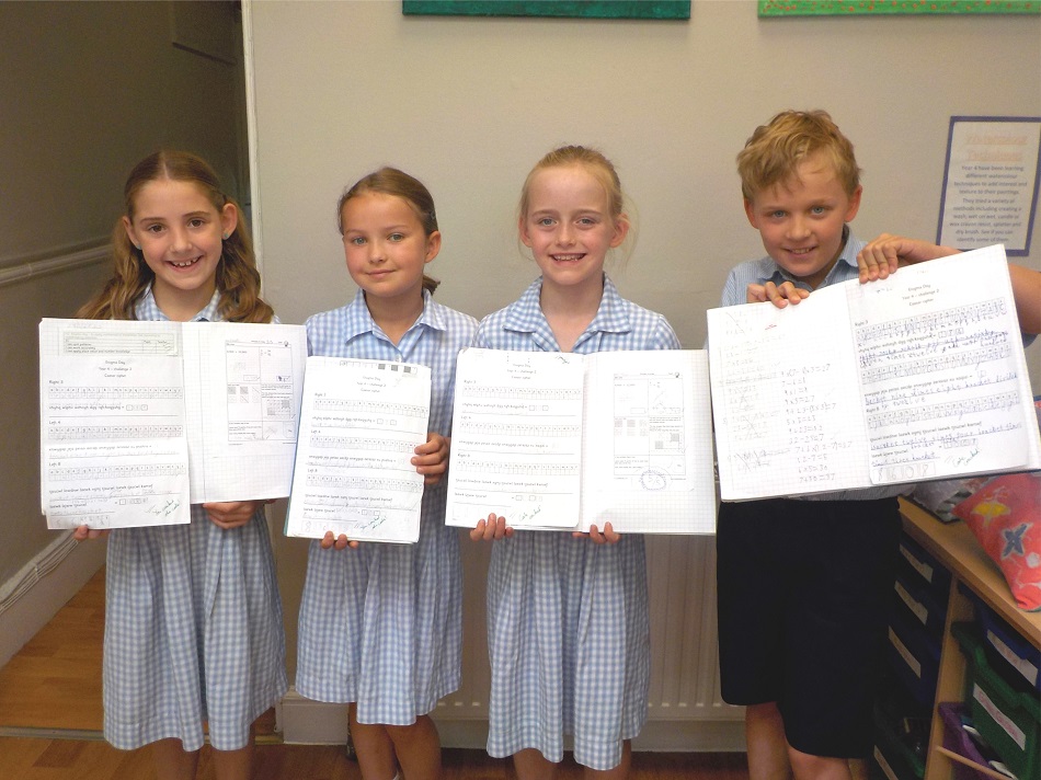 4 students with their completed codebreaking work