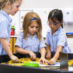 studens playing with pasta